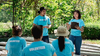 Group of volunteers for charity preparing for work in the forest park area. Environmental protection project. People and ecology concept.
