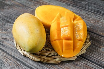 Tropical yellow mango sweet fruits with a mango slice cut