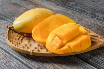 Tropical yellow mango sweet fruits with a mango slice cut