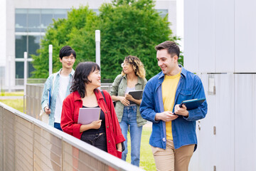 Multinational student group walking through the facility.