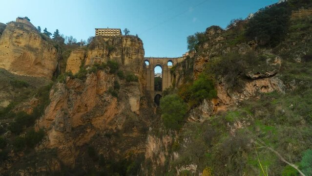Sunshine glows on Iconic Ronda bridge in Spain, time lapse