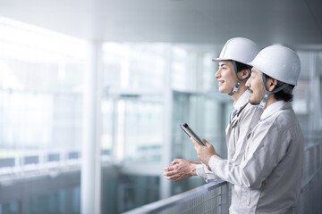 Two upper body workers staring into the future in backlight Two profiles