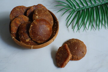 Palm sugar block against white background 