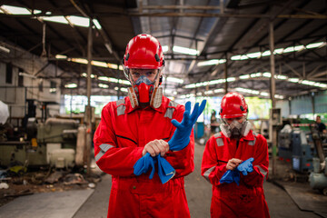 Portrait happiness industry workers with safety uniform ,blue glove and helmet to safety before...