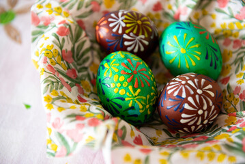 Colorful Easter eggs painted by wax in a bowl.