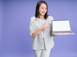 Photo of young Asian businesswoman on background