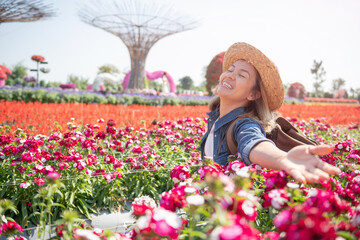 Beautiful woman enjoying flowers field, nice female lying down in meadow of flowers, pretty girl relaxing outdoor, having fun, happy young lady and spring green nature, Freedom concept.