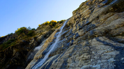 Fototapeta na wymiar beautiful mountain ridge highland fast water cascade at summertime day - photo of nature