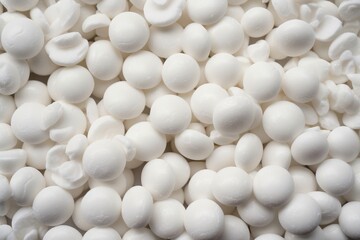  a close up of a pile of white chocolate balls with white frosting on top of them, with a black background and a white background.  generative ai