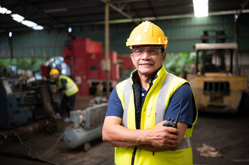 Portrait of technician team leader and team that is ready for repairing old machinery to return to normal operation in the company's old machinery warehouse