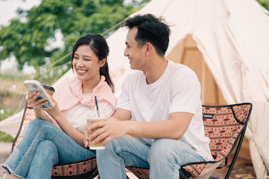 Young Asian couple camping outside