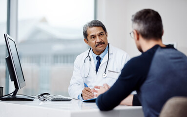 Fototapeta na wymiar Healthcare, office and doctor in a consultation with a patient in discussion on a diagnosis in the clinic. Professional, career and mature male medical worker talking to man in the medicare hospital.