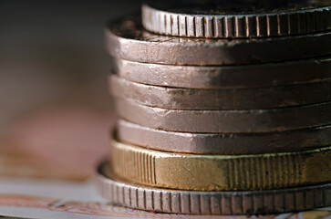 Close up side view of stack of coins