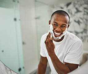 Black man, foam and happy for shaving, grooming and cosmetics in mirror for self care in home....