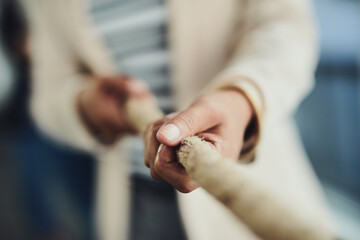 Hand, rope and team building game or tug of war with business people and collaboration, competition and closeup. Corporate conflict resolution, challenge and teamwork with employees in workplace