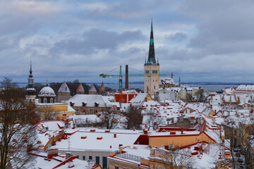 TALLINN, ESTONIA - JAN 15, 2023: Snow-covered roofs of houses in old town of Tallinn after snowfall