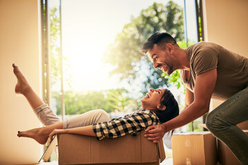 New house, funny and couple pushing box, having fun and bonding in apartment. Real estate, laughing and man and woman in cardboard, play and enjoying quality time together while moving into property. - obrazy, fototapety, plakaty