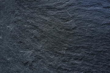 Dark wall background Cracked stone surface. Close-up. Dark rough background with copy space for design.