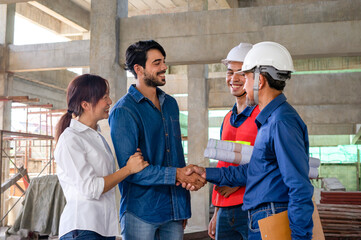 the new homeowners family, husband and wife meet contractor to inspect the progress of building a...