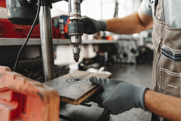 Male technician standing near tool table in car service