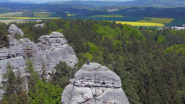 Climber on the rock. Beautiful aerial top view flight 
czech republic mary rock view nature hills mountains bohemian paradise spring 2023. drone top down Above
4k uhd cinematic footage.