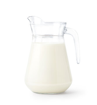 A glass pitcher of fresh milk isolated on white background. Clipping path.