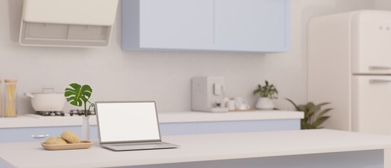 A laptop mockup on a white kitchen island in minimal kitchen in white and blue style.