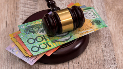 Australian dollars under judge's gavel close up
