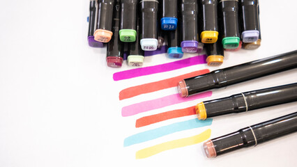 Colorful marker pens on white background with copy space for text.