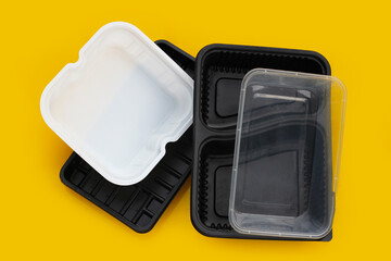 Plastic food packaging on yellow background.