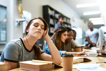 Woman, tired and books for studying at library, college or campus with stress, anxiety or burnout. University student, girl and headache with education, study and fatigue on face at school with sleep