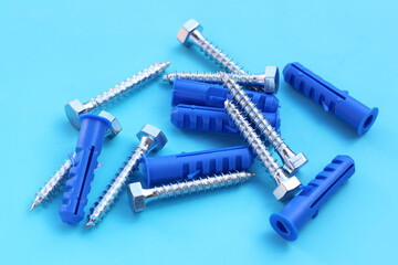 Steel screws on blue background.