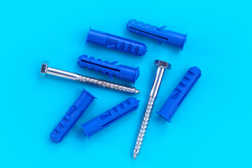 Steel screws on blue background.