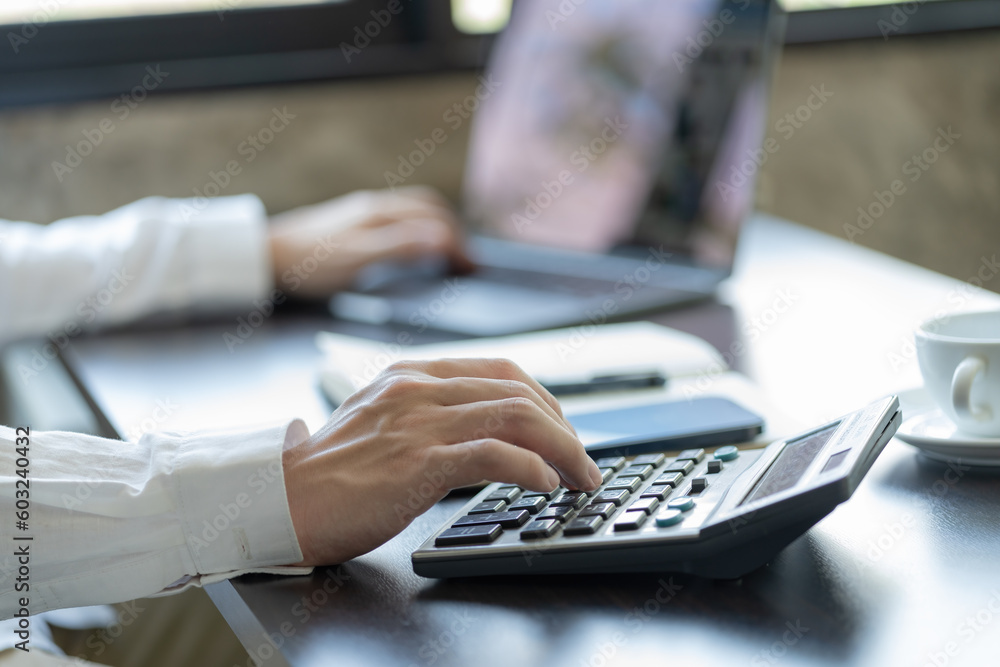 Poster businessman using a calculator to calculate the numbers