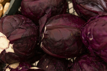 Fototapeta na wymiar Lots of heads of red cabbage on the counter in the store. Organic food and health. Close-up.