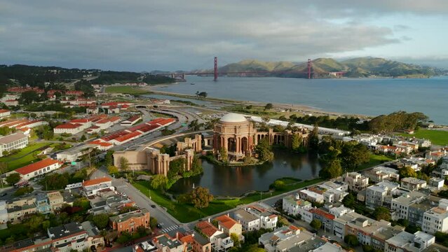 Morning arial flying around Bay Area near Palace of Fine Arts with cinematic sunrise and Golden Gate Bridge on background. San Francisco. California. 4K Hi Quality drone footage