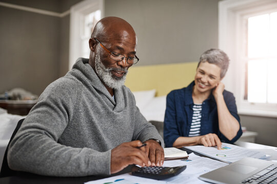 Calculator, documents or finance with an old couple busy on a budget review in the home together. Accounting, taxes or investment with a senior man and interracial woman planning insurance or savings