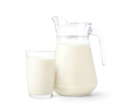 Glass and pitcher of fresh milk isolated on white background. Clipping path.