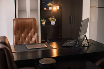 Director's office with large wooden table, leather armchair and PC. Interior design