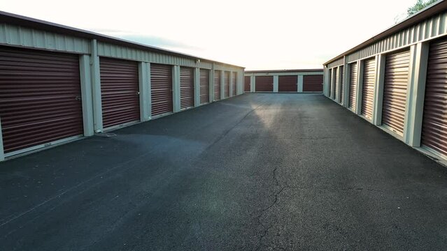 Self storage units in USA. Bright sunset over warehouse temporary storage. Aerial establishing shot.