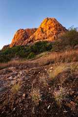 a field with a mountain in the background at Castle Hill Townsville