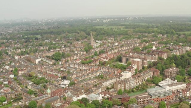 Wide circling aerial shot over Richmond Town West London towards St Matthias church