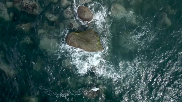Scenic View Of Clean Ocean Water Waves Splashing On Rocks On The Sea In San Pancho, Mexico. aerial topdown