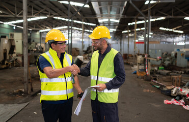 Portrait of technician team leader and team that is ready for repairing old machinery to return to normal operation in the company's old machinery warehouse