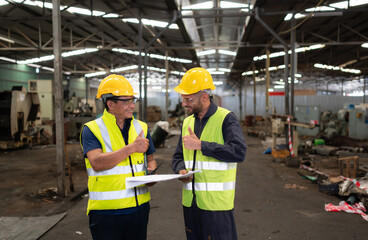 Portrait of technician team leader and team that is ready for repairing old machinery to return to normal operation in the company's old machinery warehouse
