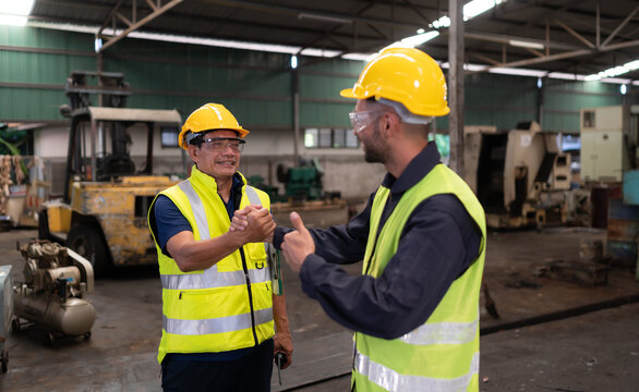 Portrait of technician team leader and team that is ready for repairing old machinery to return to normal operation in the company's old machinery warehouse