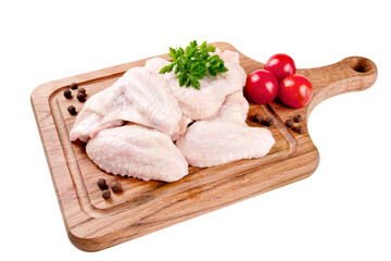 Raw chicken wings on a cutting board on a white background.