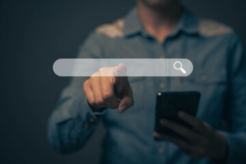 Businessman touching the screen with his finger. Searching for various information with internet technology