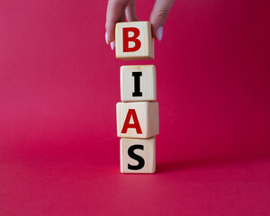 Bias symbol. Concept word Bias on wooden cubes. Businessman hand. Beautiful red background. Business and Bias concept. Copy space.