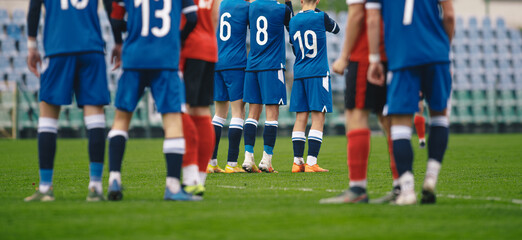 Soccer players standing in a wall during free kick